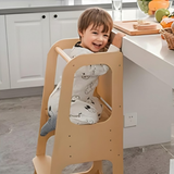 Child sitting in a wooden chair in a kitchen