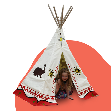 Young girl peeking out of a cream-coloured wigwam teepee decorated with desert prints, including suns, rabbits, and red zigzag patterns