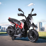 Black and red motorcycle with 'Aprilia' branding on a city street background