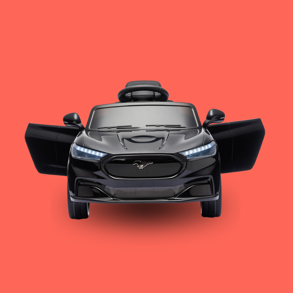 A black Ford Mustang-themed kids' ride-on toy car with butterfly-style open doors, shown from a front-facing overhead angle on a solid coral-red background.