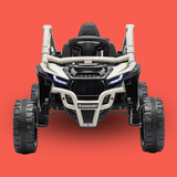 A Kawasaki four-wheeler dirt bike in white and black with green accents, shown from a front-facing perspective against a solid red-orange background.