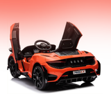 An orange and black toy sports car ride-on with butterfly-style open doors, shown on a clean white-to-pink gradient background.