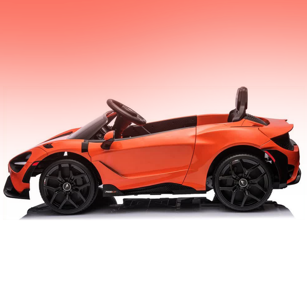 An orange and black toy convertible sports car, styled like a McLaren, shown in a side profile on a reflective white surface with a pink gradient background.