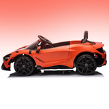 An orange and black toy convertible sports car, styled like a McLaren, shown in a side profile on a reflective white surface with a pink gradient background.