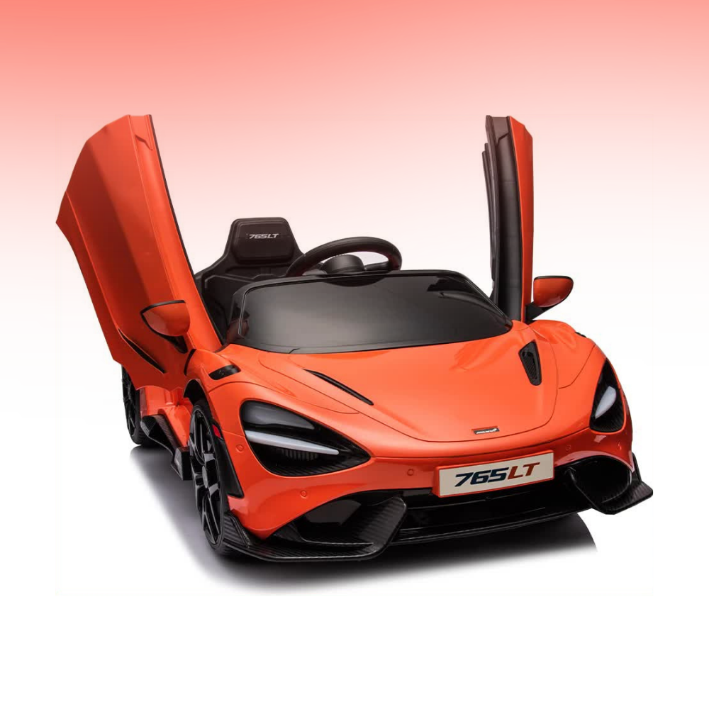 An orange and black toy convertible ride-on car styled like a McLaren 765LT, featuring open butterfly doors and a black interior, shown on a white background with a pink gradient.