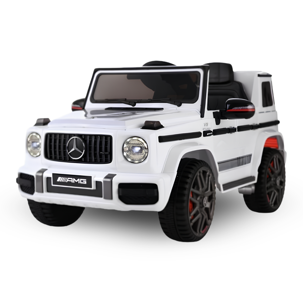 A white Mercedes-Benz AMG kids' ride-on toy car styled like a G-Class SUV, featuring black seats, black wheels, and red accents on the wheel rims, shown against a plain white background.