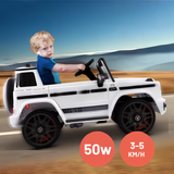 A young child wearing a blue shirt sits in a white ride-on toy car designed to look like a Mercedes-Benz G-Class, driving on a sandy road with a blue sky background. Two orange circular badges at the bottom right display '50W' and '3-5 KM/H'.