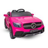 A bright pink Mercedes-Benz GLC Coupe ride-on toy car with a black steering wheel and black grille, shown on a clean white background.