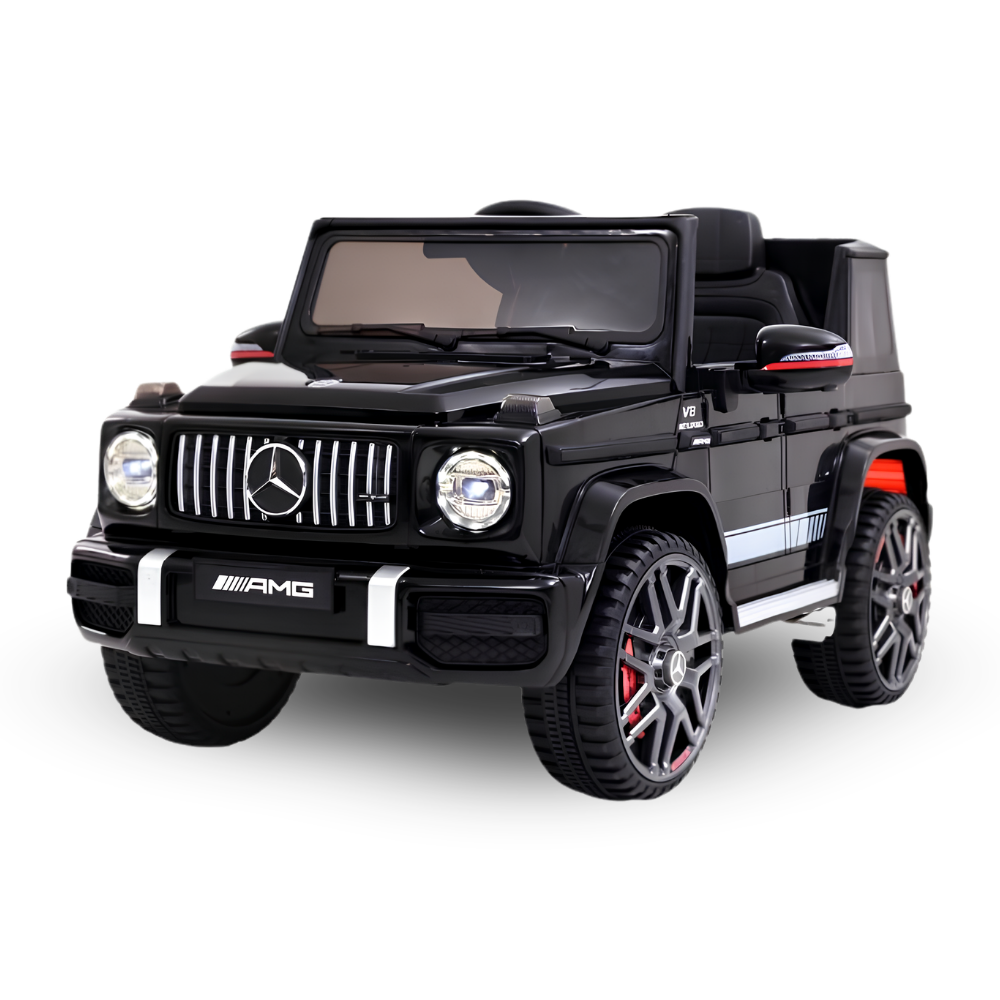 A black Mercedes-Benz G-Class style ride-on toy car with AMG branding, shown on a clean white background. The toy features a glossy black finish, detailed gray wheels with red accents, and chrome grille details.