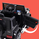 Black Mercedes-Benz G63 style children's ride-on toy car with an open door and white arrow graphic indicating a feature, shown on a solid red background.