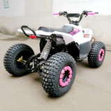 Small ATV with pink wheels on a concrete floor