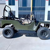 Green off-road vehicle with large tires on a concrete surface.