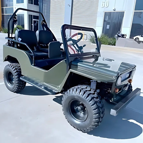 Small off-road vehicle on a concrete surface with a building in the background