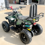 Green ATV with a black seat and rear rack on a concrete surface.