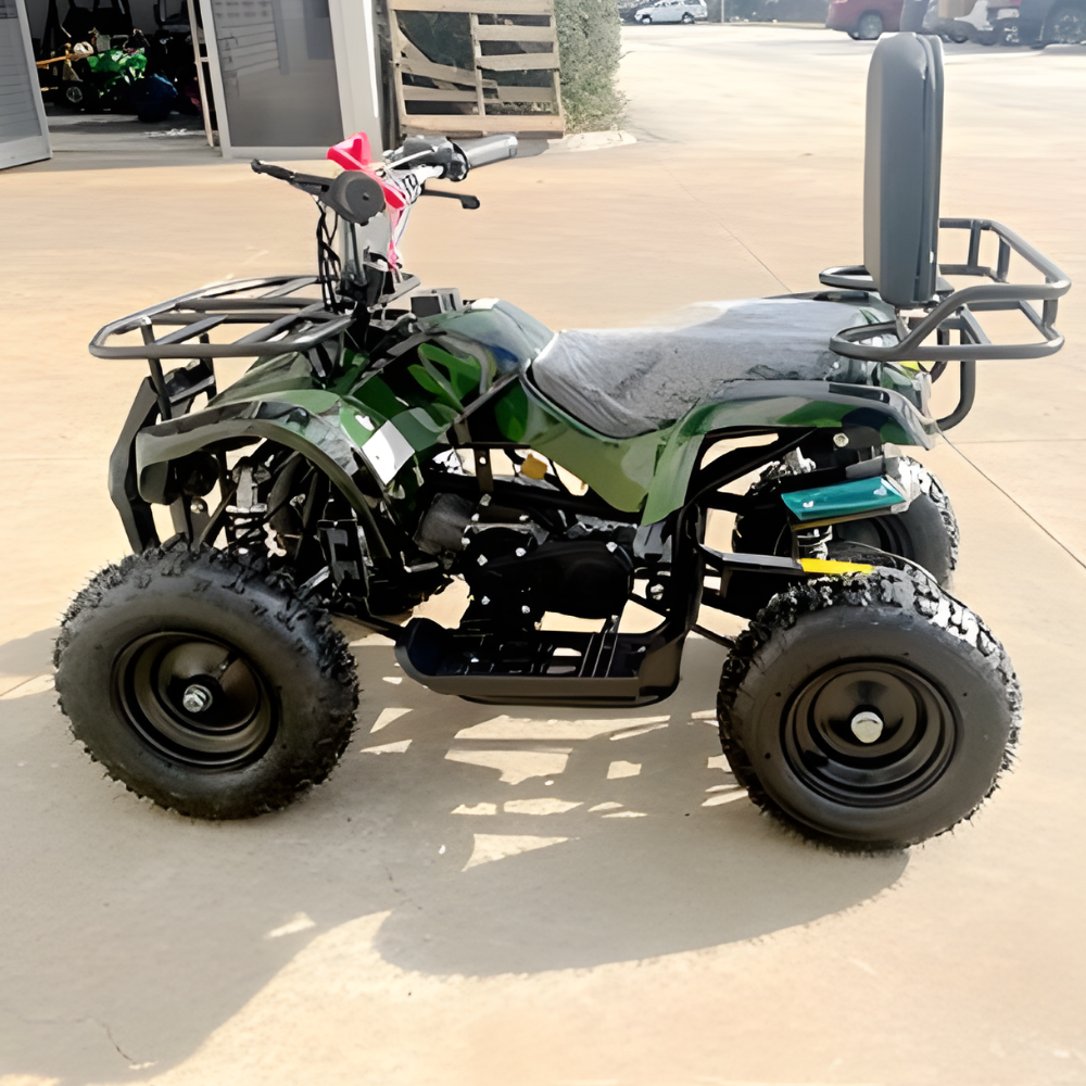 Green ATV parked on a concrete surface with a building in the background