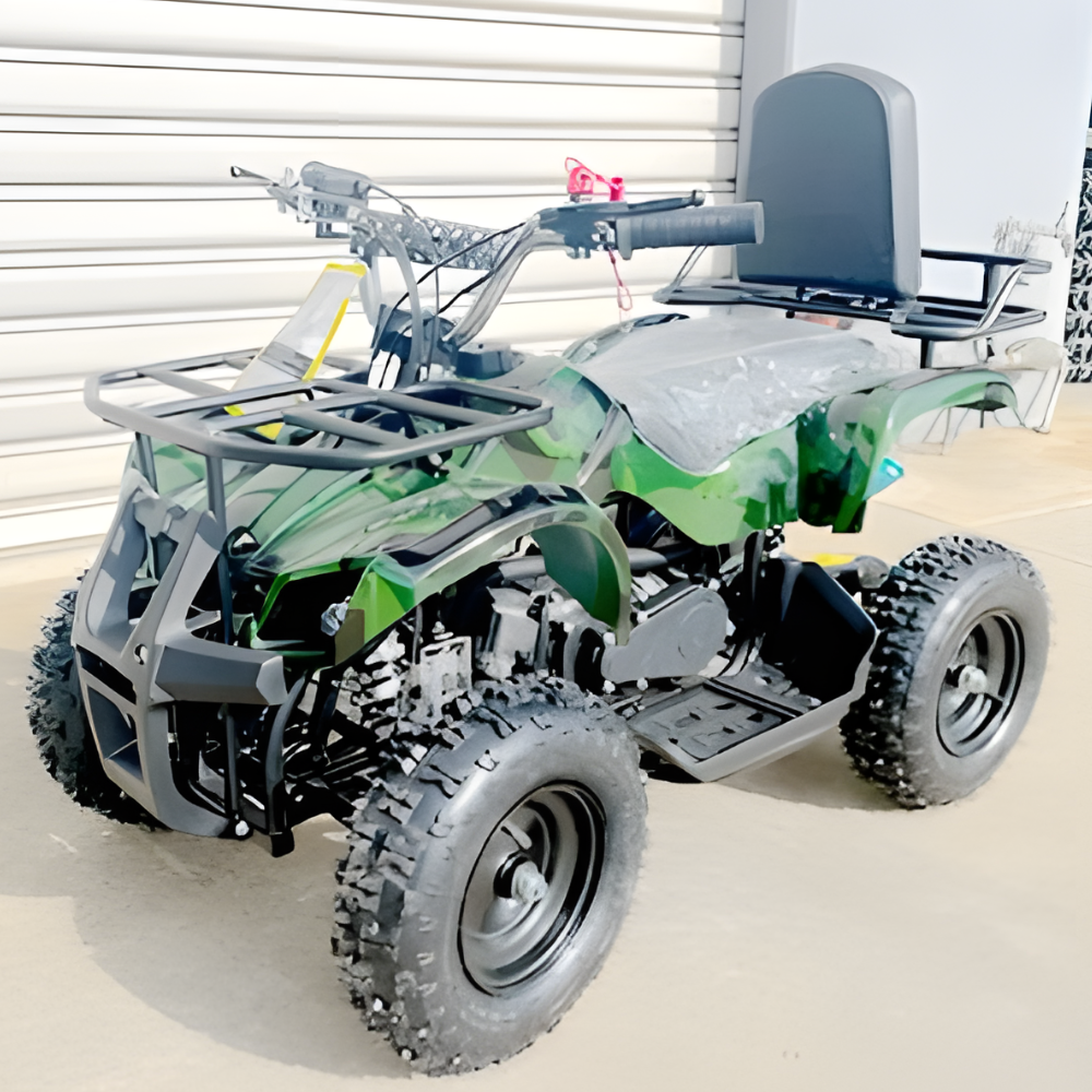 Green and gray ATV on a concrete surface with a white wall in the background