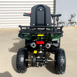 Back view of a small off-road vehicle with large tires on a concrete surface.
