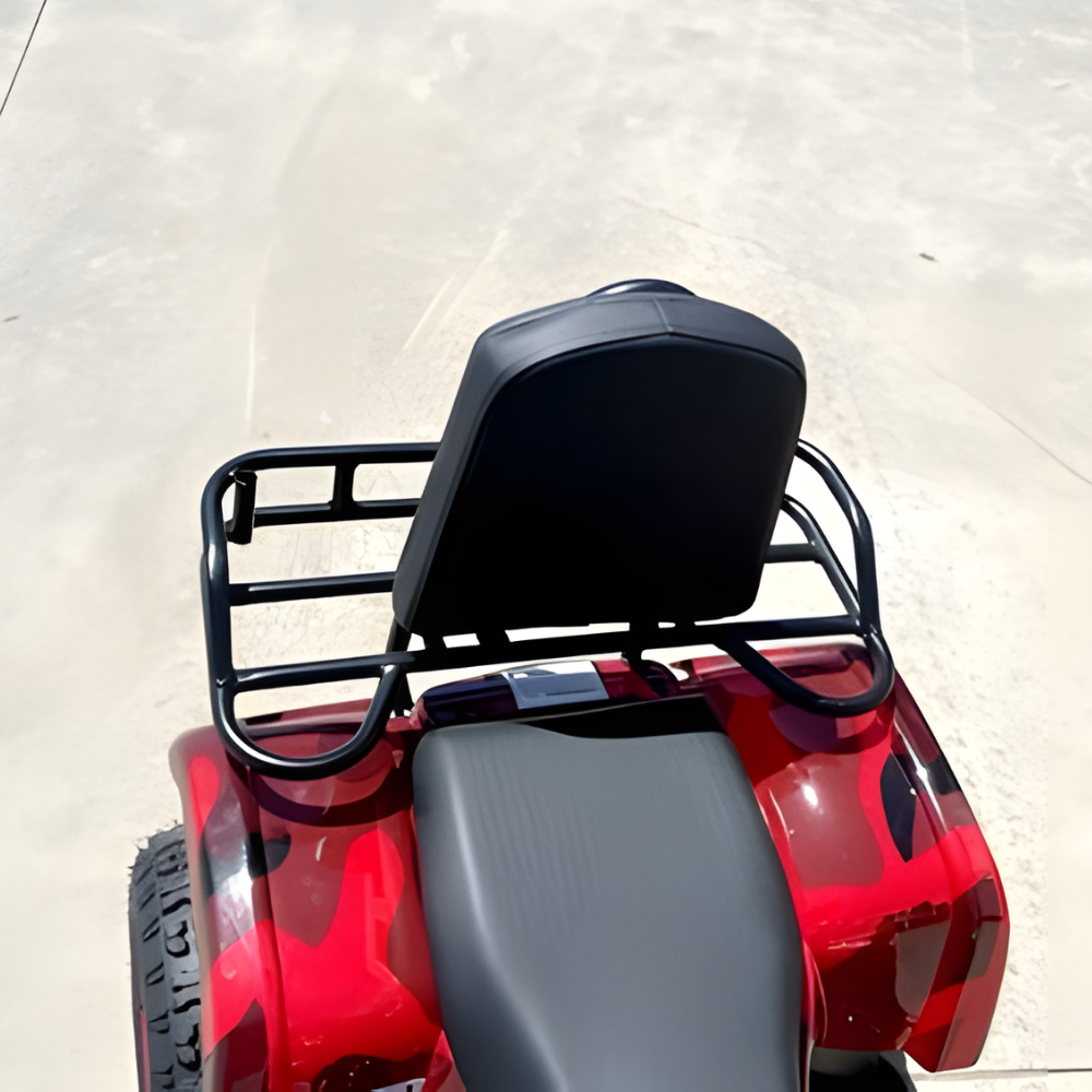 Red ATV with black seat and rack on a light background