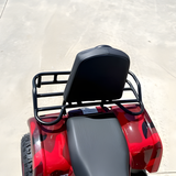 Red ATV with black seat and rack on a light background