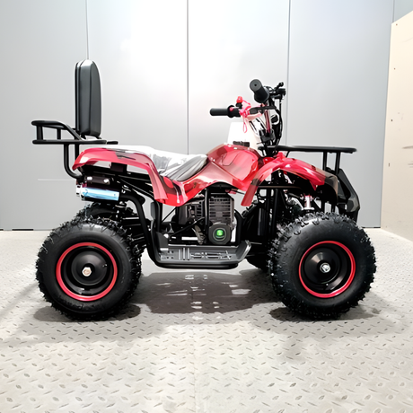 Red and black ATV on a gray floor with a white wall background