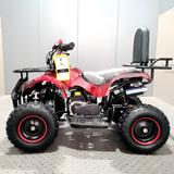 Red and black ATV on a gray platform with a white wall background