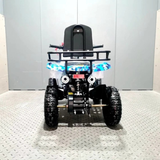 toy quad bike with lights on a textured floor against a plain wall