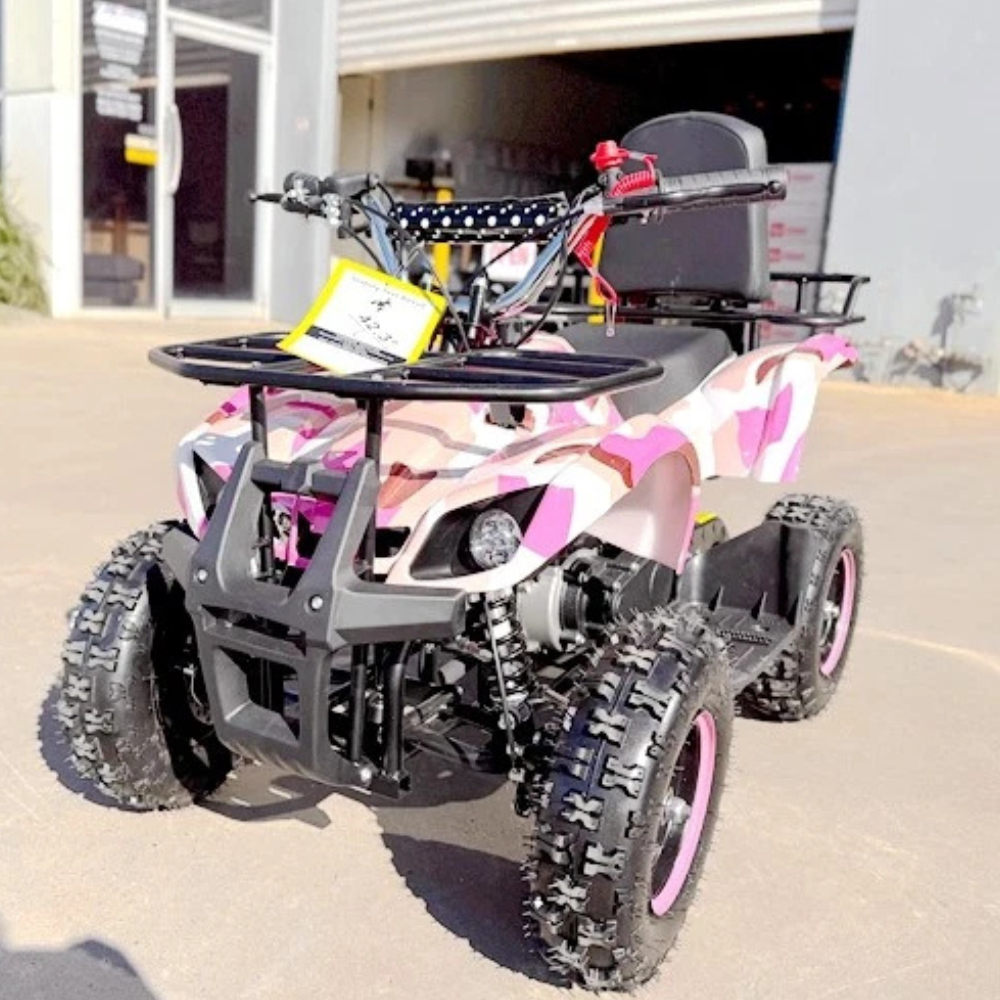 Pink and black quad bike on a driveway