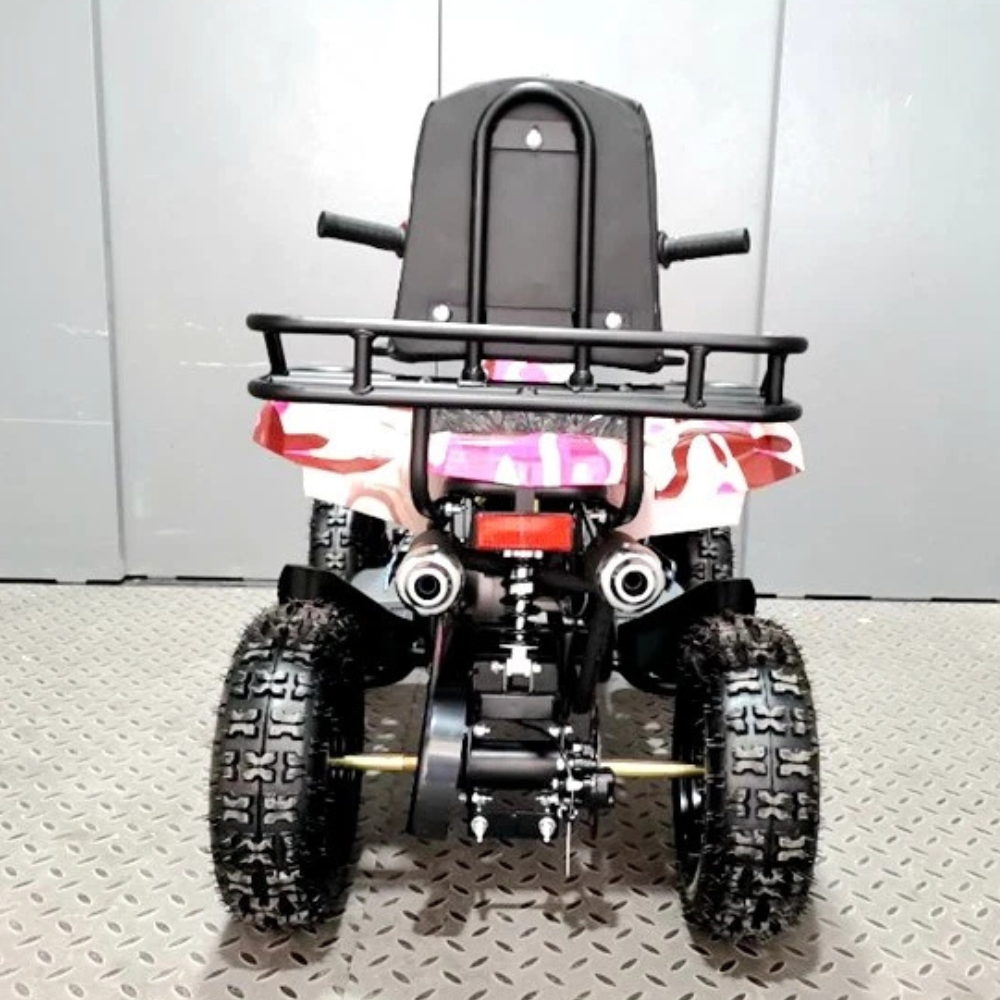 Children's ATV with a seat and front rack on a gray floor.