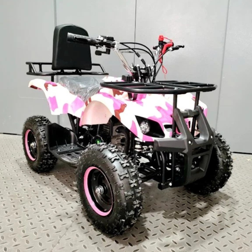 Pink and black quad bike on a gray floor with a white wall background