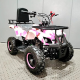 Pink and black quad bike on a gray floor with a white wall background