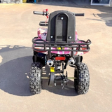 Back view of a pink and black quad bike on a concrete surface