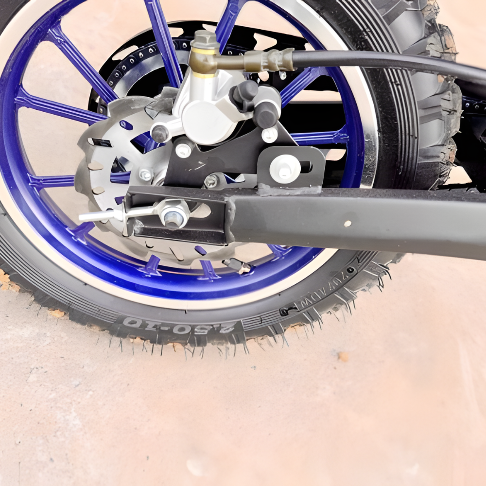 Close-up of a motorcycle wheel with blue rim and visible brand name on a beige background