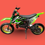 Green and black children's dirt bike on a red background