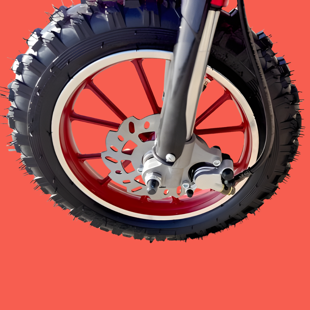 Close-up of a motorcycle wheel with knobby tires on a red background