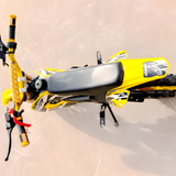 Yellow and black dirt bike on a sandy surface