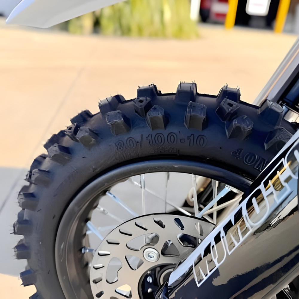 Close-up of a motorcycle tire with treads on a blurred background