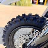 Close-up of a motorcycle tire with treads on a blurred background