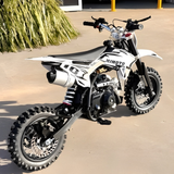 White dirt bike with black accents on a sandy surface