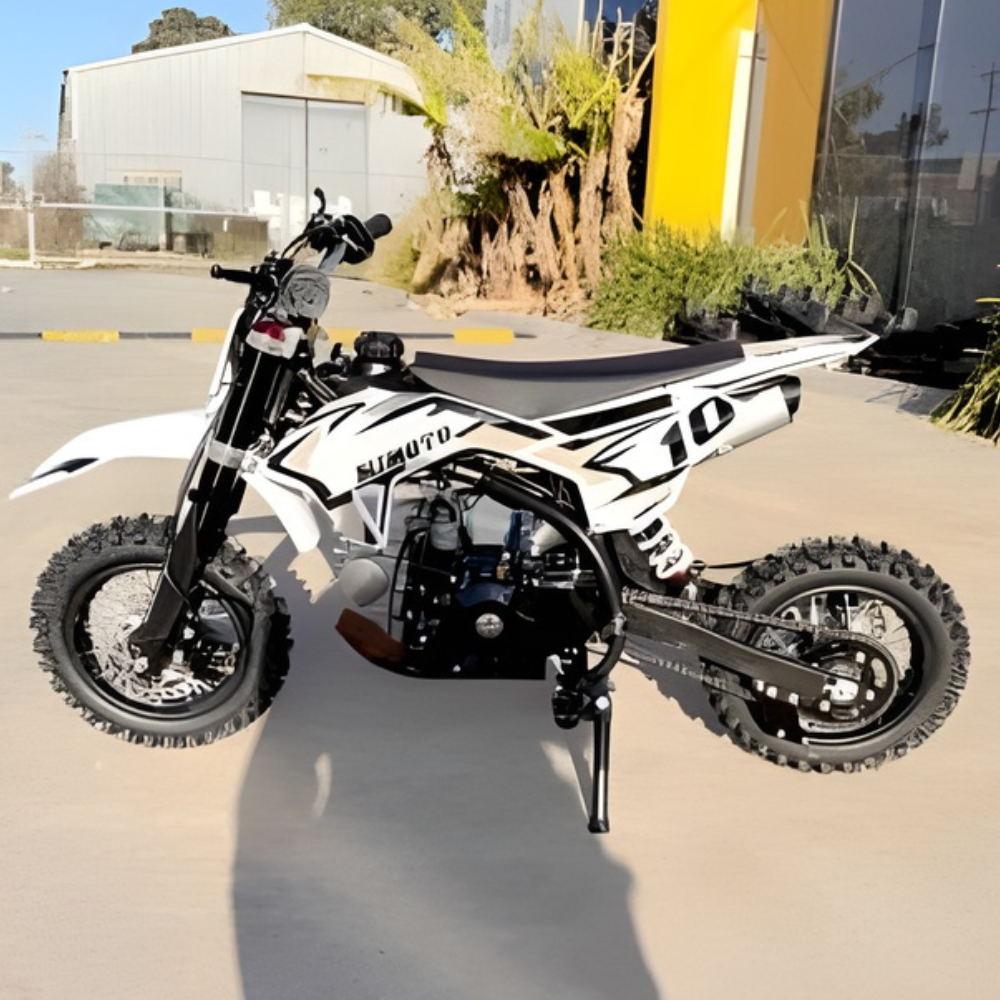 White and black dirt bike on a paved surface.
