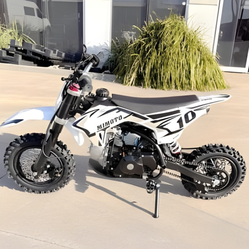 White and black dirt bike with 'Mimoto' branding on a concrete surface.
