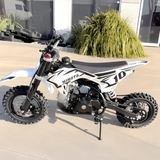 White and black dirt bike with 'Mimoto' branding on a concrete surface.