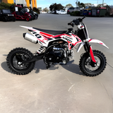 Small dirt bike with Mimoto branding on a concrete surface.