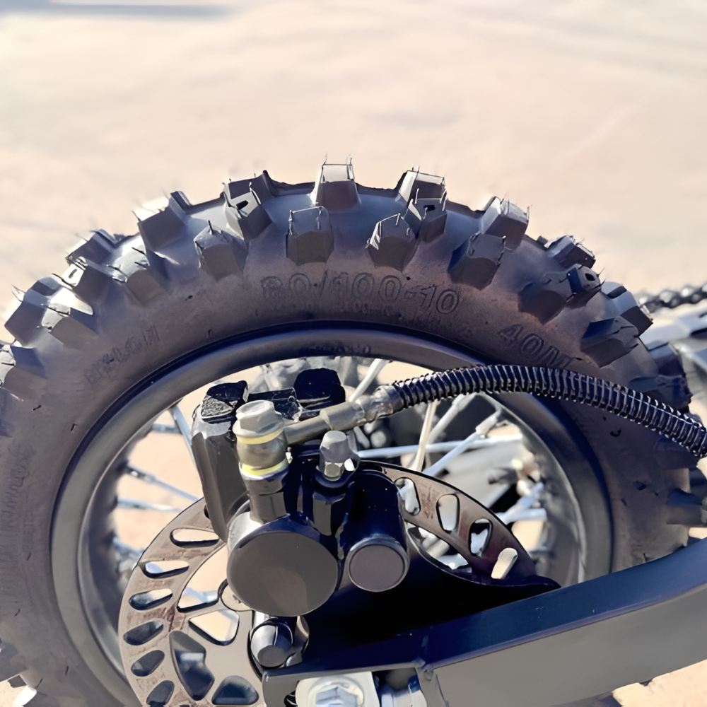 Close-up of a motorcycle wheel with tire and suspension components.