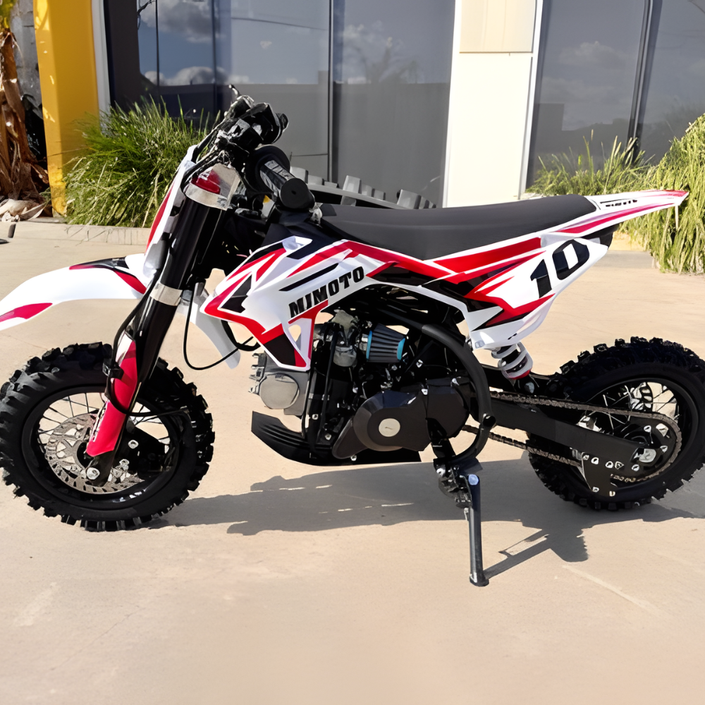 Mimoto dirt bike with red and white design on a concrete surface.