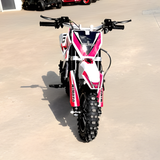 Small dirt bike with a red and white design on a concrete surface