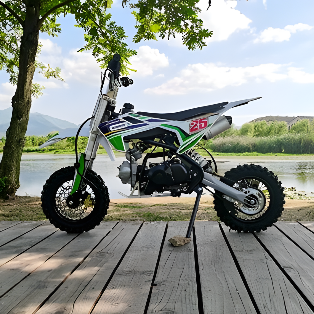 Small dirt bike on a wooden platform with a scenic background of water and trees.