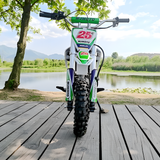 Children's dirt bike on a wooden deck with a scenic background of trees and water.