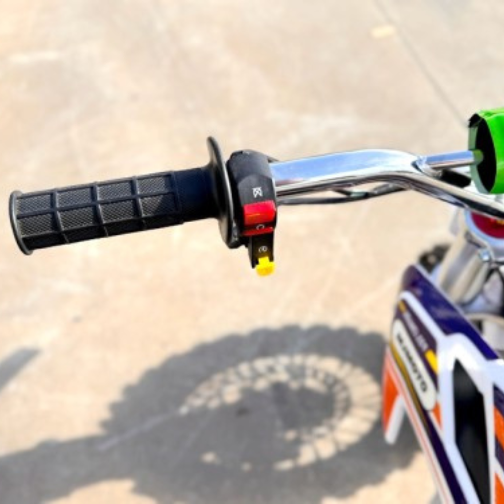 Close-up of a motorcycle handlebar with grips and controls on a blurred road background