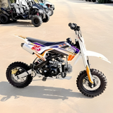 Small dirt bike with colorful design on a paved surface