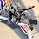 Close-up of a motorcycle handlebar with throttle and brake lever.
